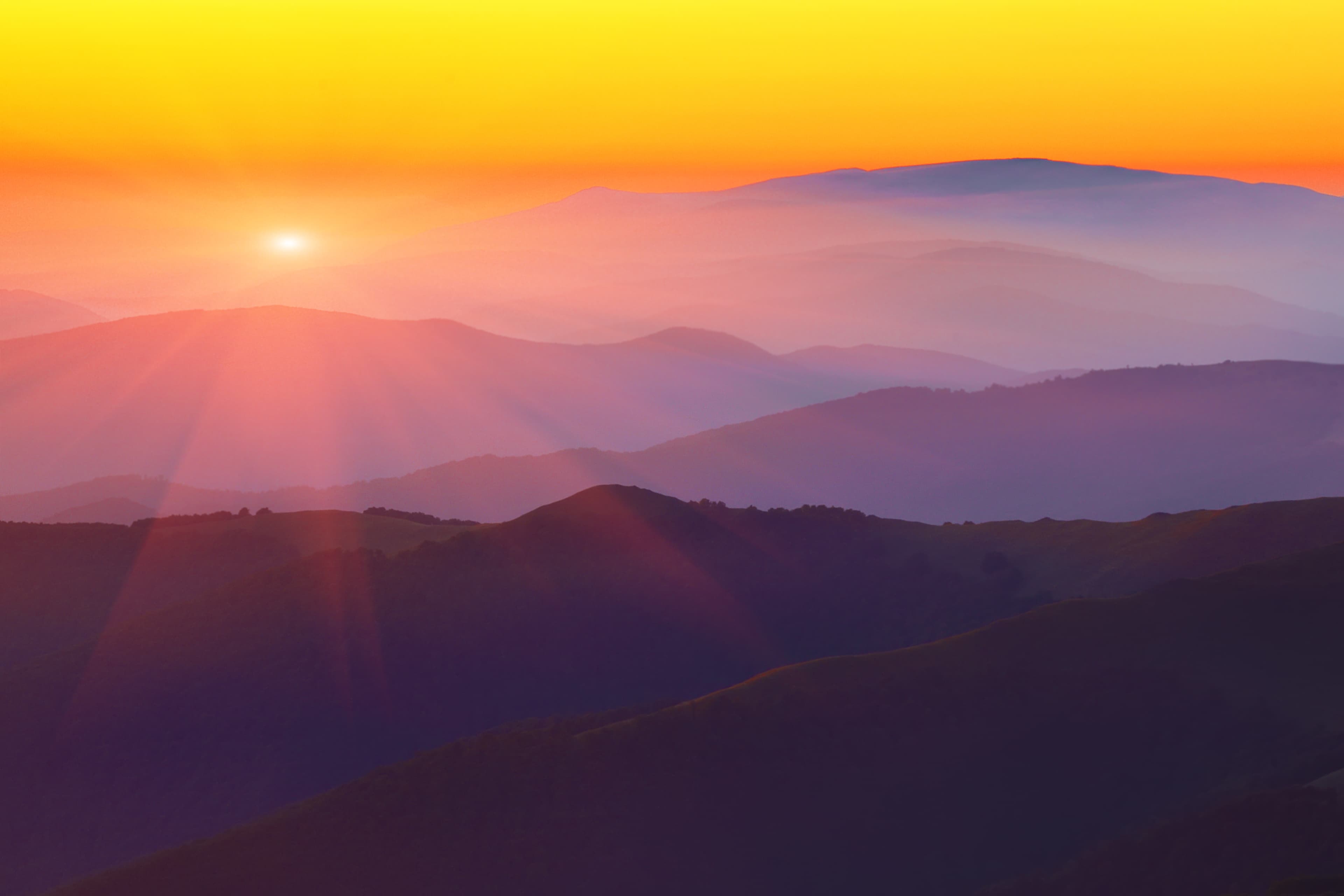 Silhouettes of mountain hills at sunset